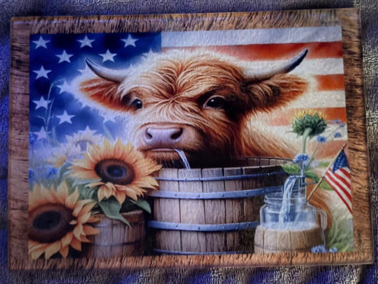 Highland cow drinking out of bucket cutting board