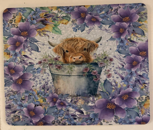 Highland cow with purple flowers mouse pad