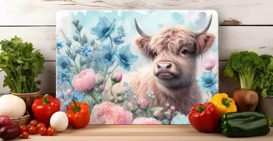 Highland cow with pink and blue flowers glass cutting board